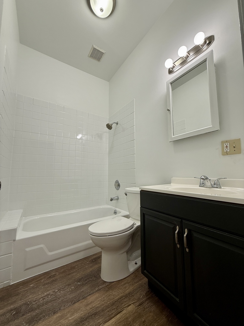 556 West 37th Street, Unit 3F Chicago, IL 60609 - Photo 11 of 12 a bathroom with a sink toilet a mirror and bathtub