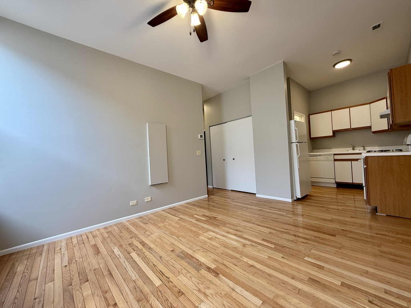 556 West 37th Street, Unit 3F Chicago, IL 60609 - Photo 4 of 12 a view of a kitchen with wooden floor a sink a refrigerator and window