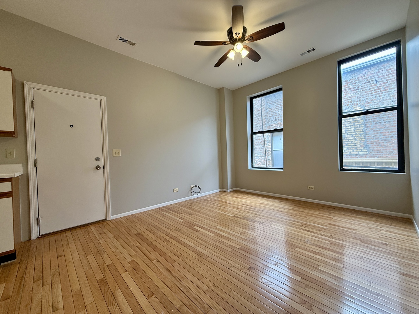556 West 37th Street, Unit 3F Chicago, IL 60609 - Photo 6 of 12 a view of an empty room with window and wooden floor