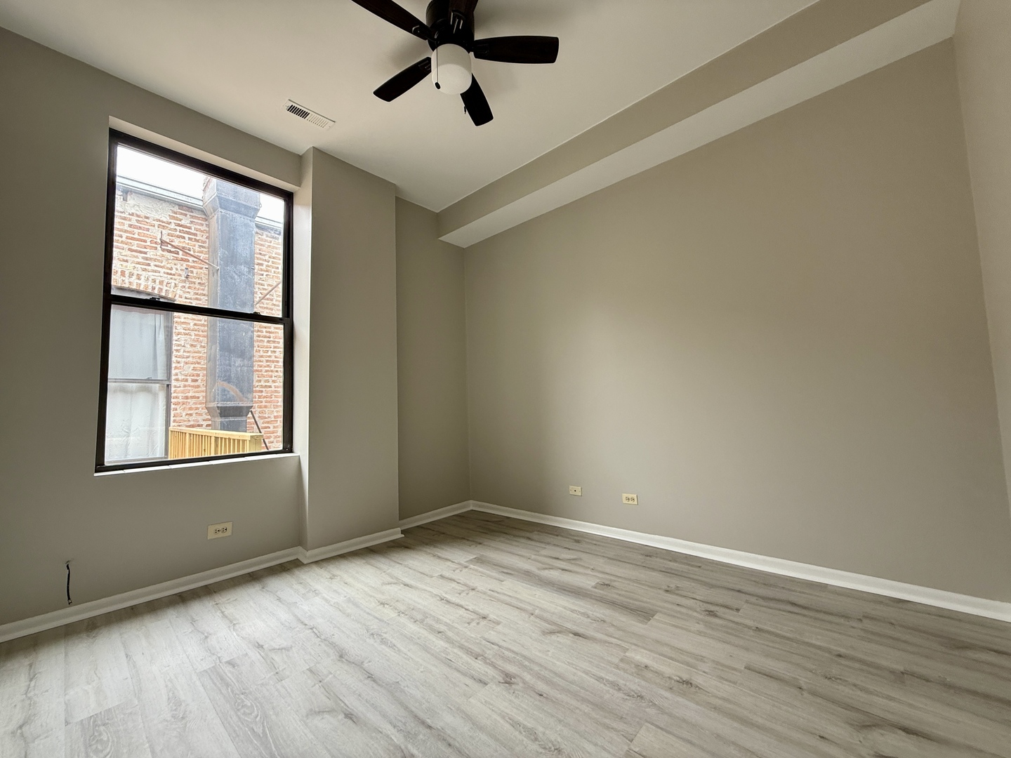 556 West 37th Street, Unit 3F Chicago, IL 60609 - Photo 8 of 12 a view of an empty room with wooden floor and a window