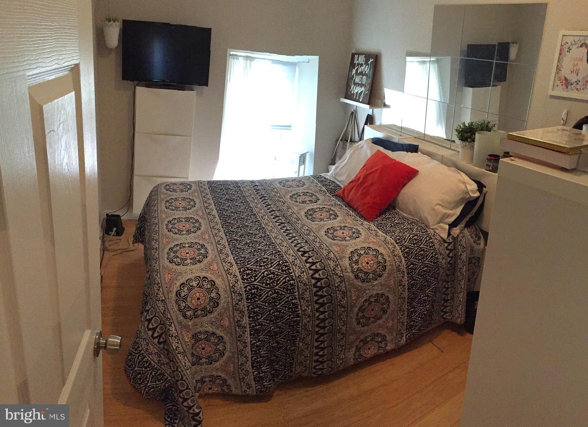 4203 Main Street, Unit 2 Philadelphia, PA 19127 - Photo 16 of 16 a bedroom with a bed and a television