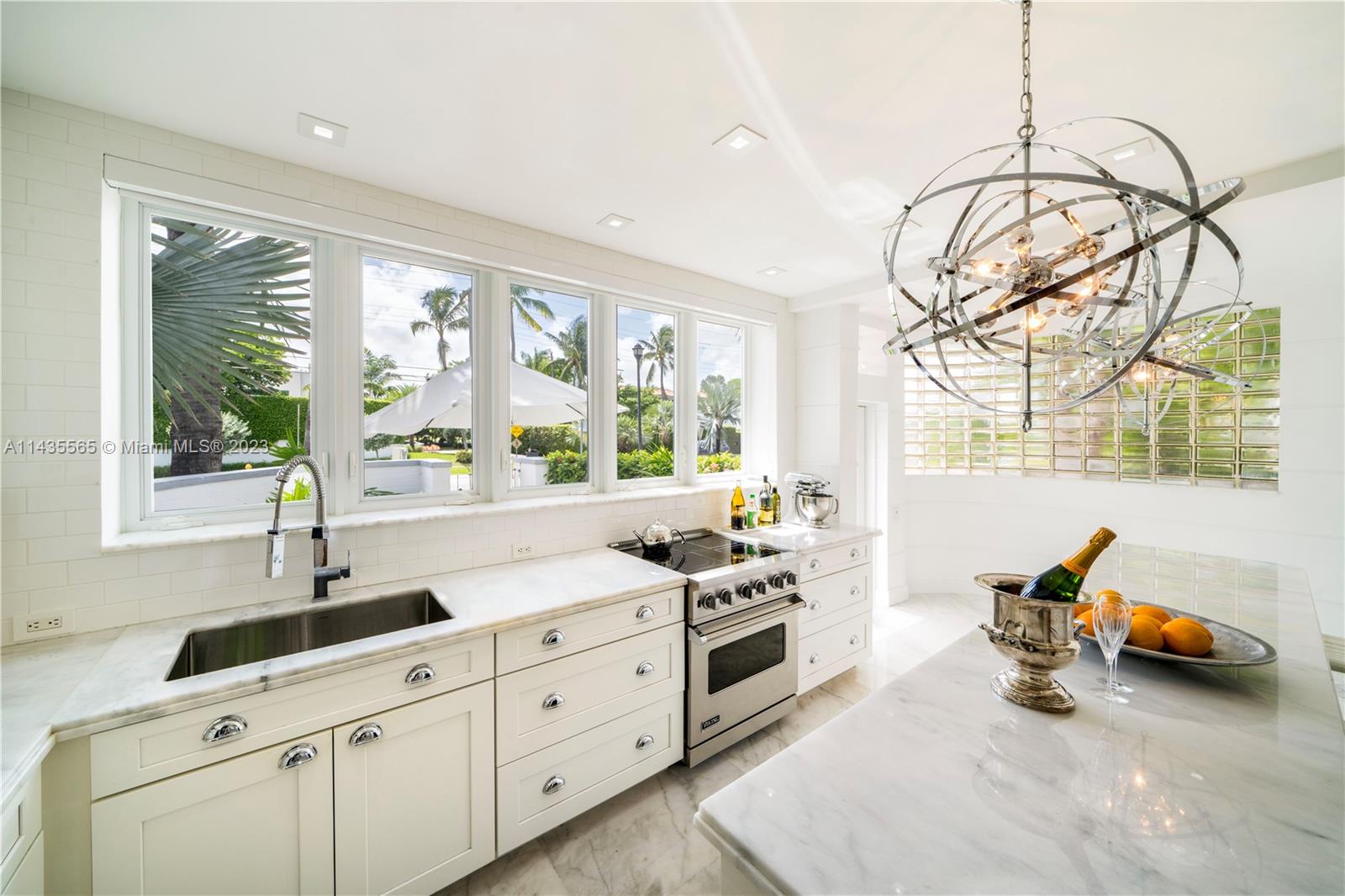 5959 La Gorce Drive Miami Beach, FL 33140 - Photo 12 of 60 a kitchen that has a sink and a stove