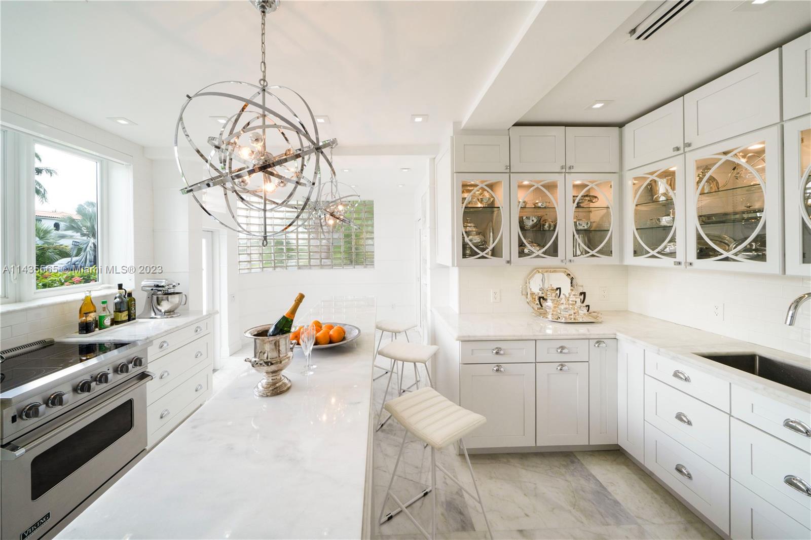 5959 La Gorce Drive Miami Beach, FL 33140 - Photo 13 of 60 a kitchen with a sink stove and cabinets
