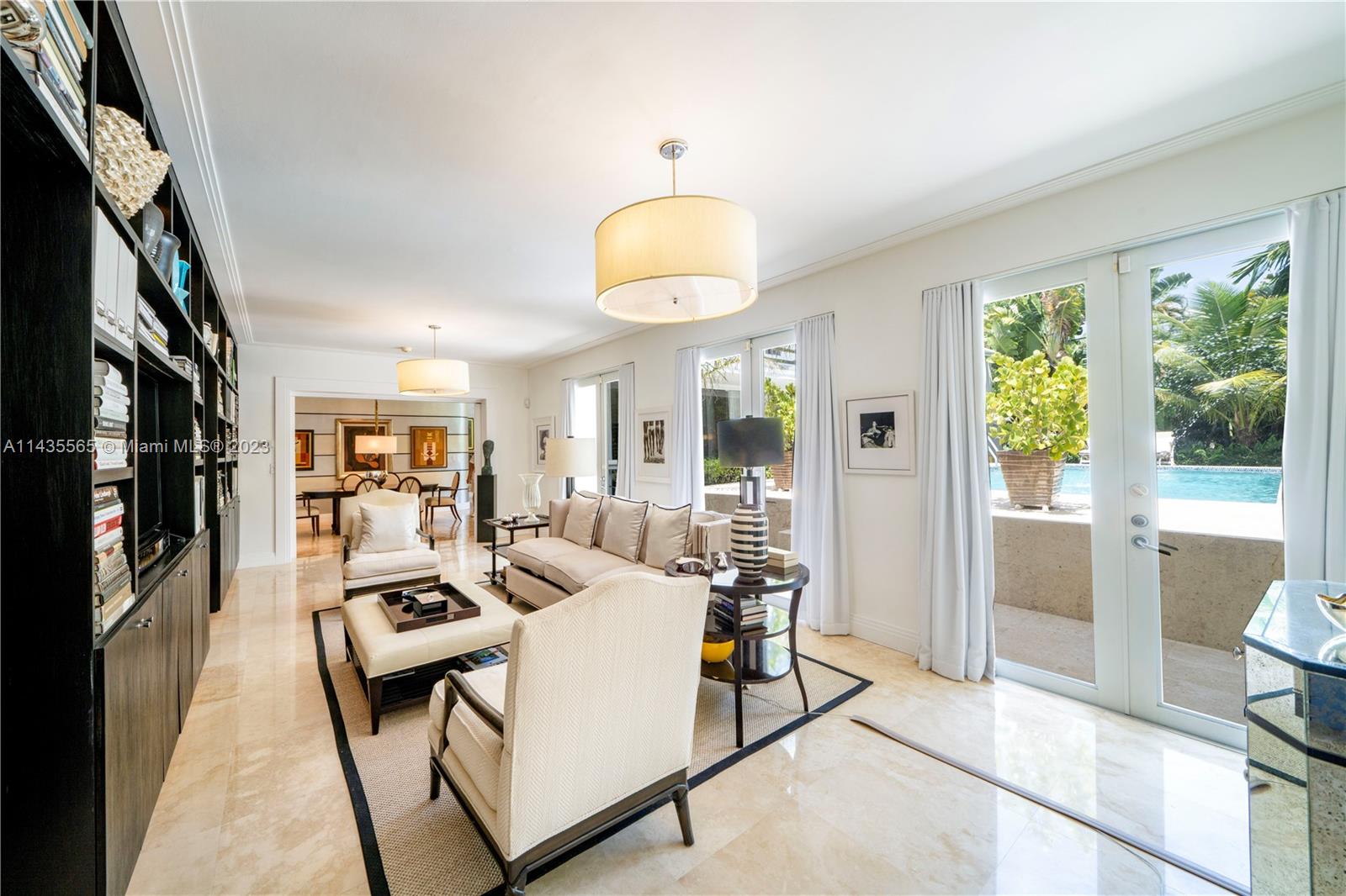 5959 La Gorce Drive Miami Beach, FL 33140 - Photo 17 of 60 a living room with furniture a window and a flat screen tv
