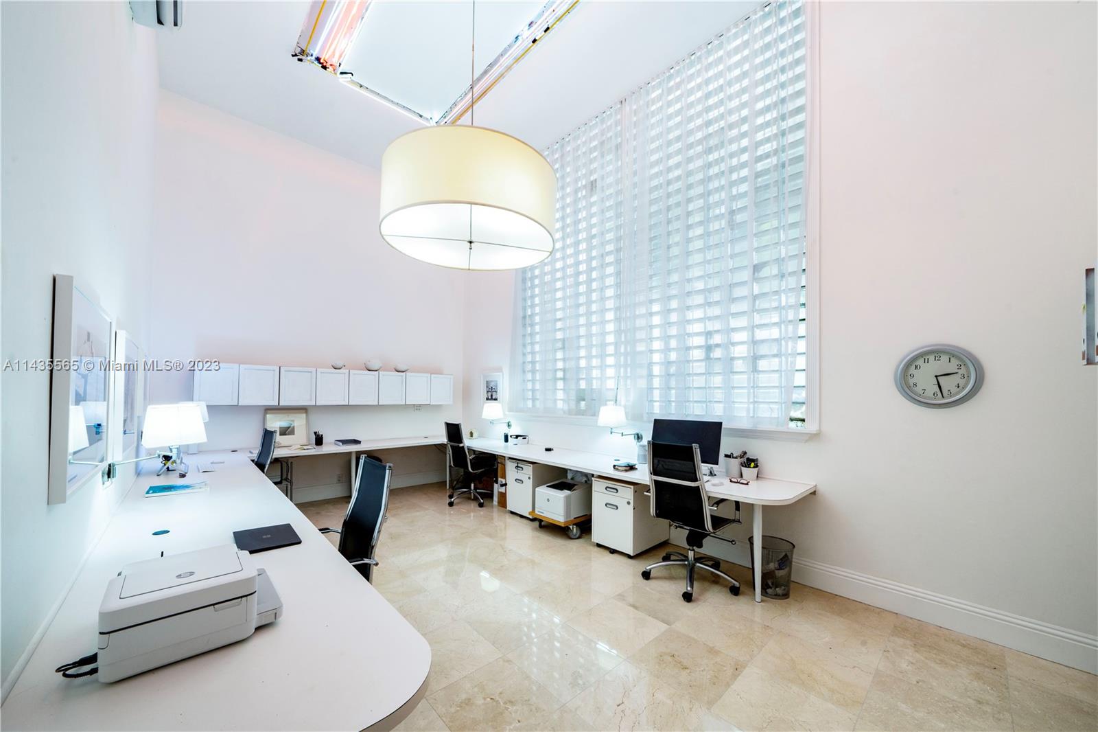 5959 La Gorce Drive Miami Beach, FL 33140 - Photo 22 of 60 a living room with furniture a rug and a chandelier