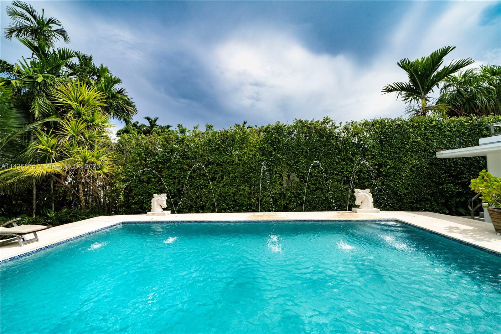 5959 La Gorce Drive Miami Beach, FL 33140 - Photo 30 of 60 a view of yard with swimming pool and lawn chairs