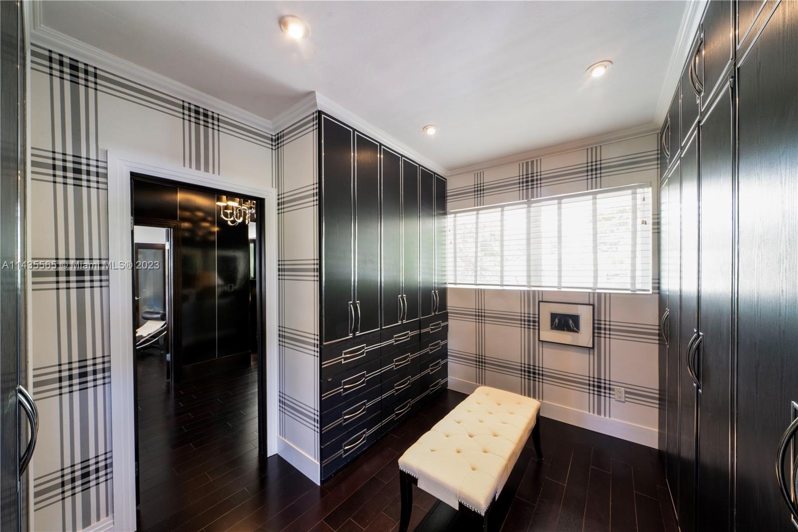 5959 La Gorce Drive Miami Beach, FL 33140 - Photo 35 of 60 a kitchen with granite countertop stainless steel appliances and wooden cabinets