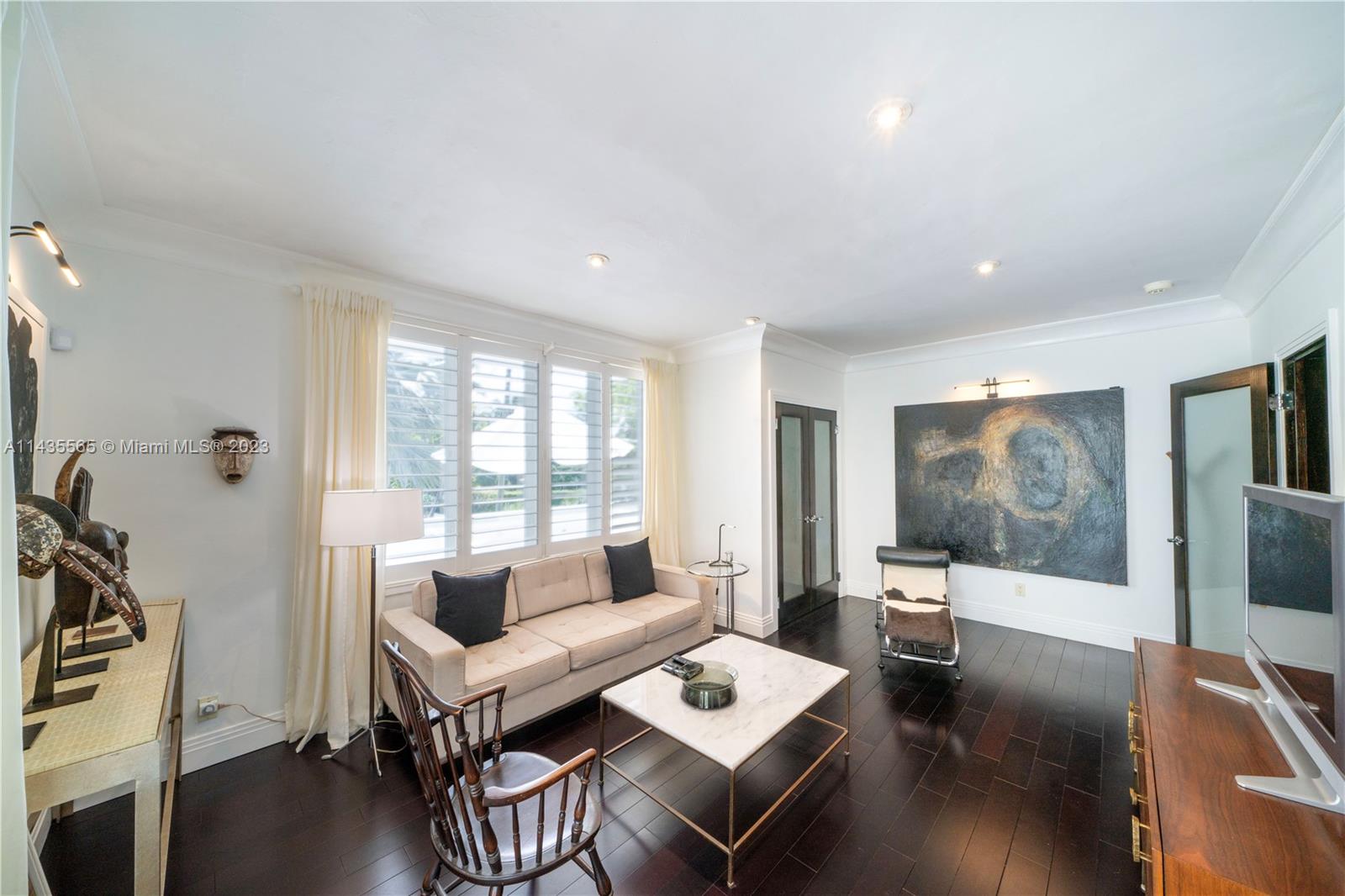 5959 La Gorce Drive Miami Beach, FL 33140 - Photo 36 of 60 a living room with furniture and a flat screen tv