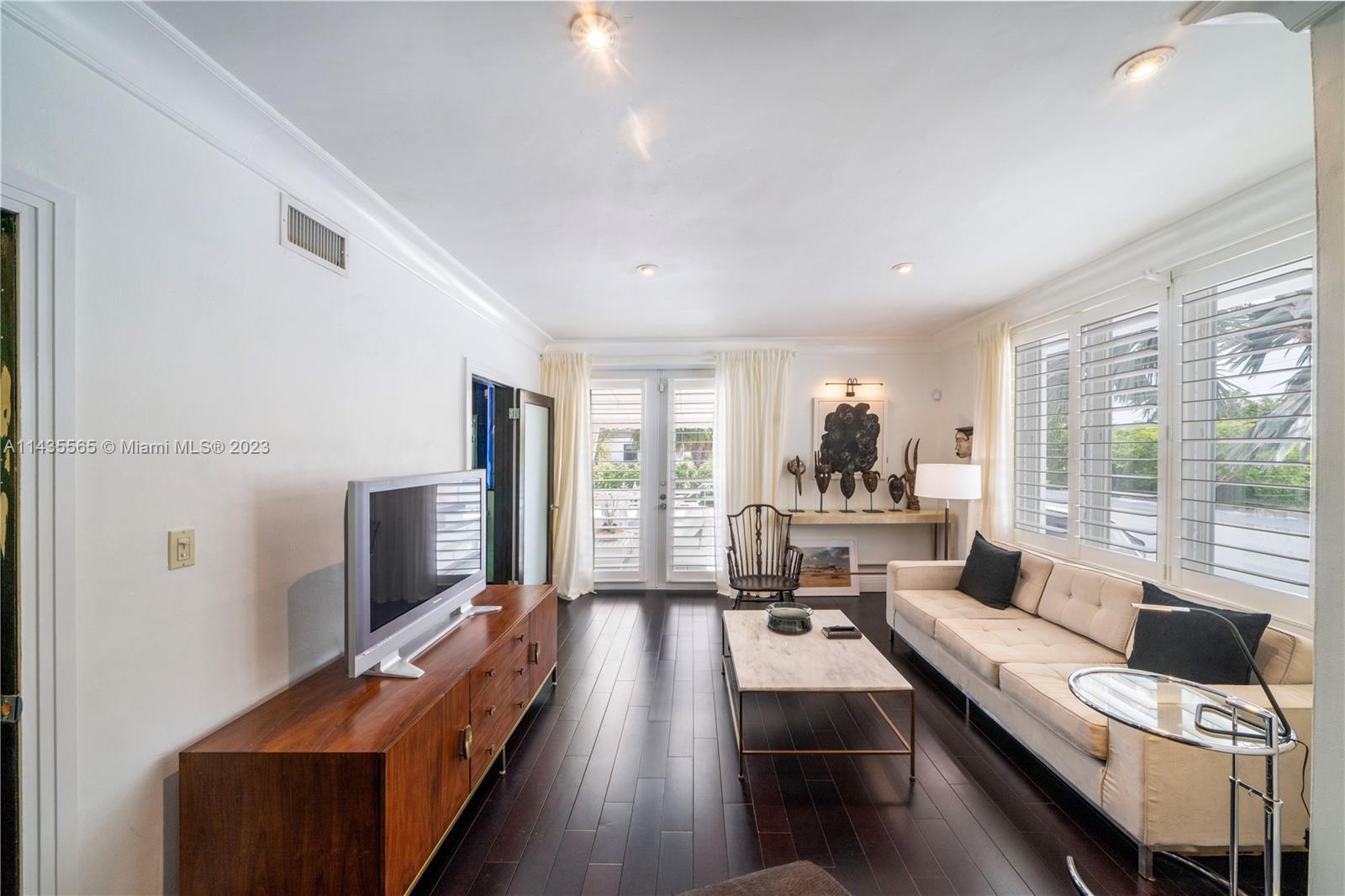 5959 La Gorce Drive Miami Beach, FL 33140 - Photo 37 of 60 a living room with furniture and a flat screen tv