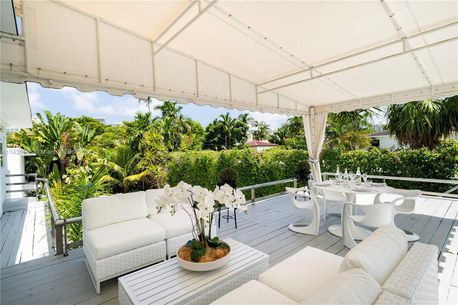 5959 La Gorce Drive Miami Beach, FL 33140 - Photo 39 of 60 a view of a patio with couches table and chairs and potted plants