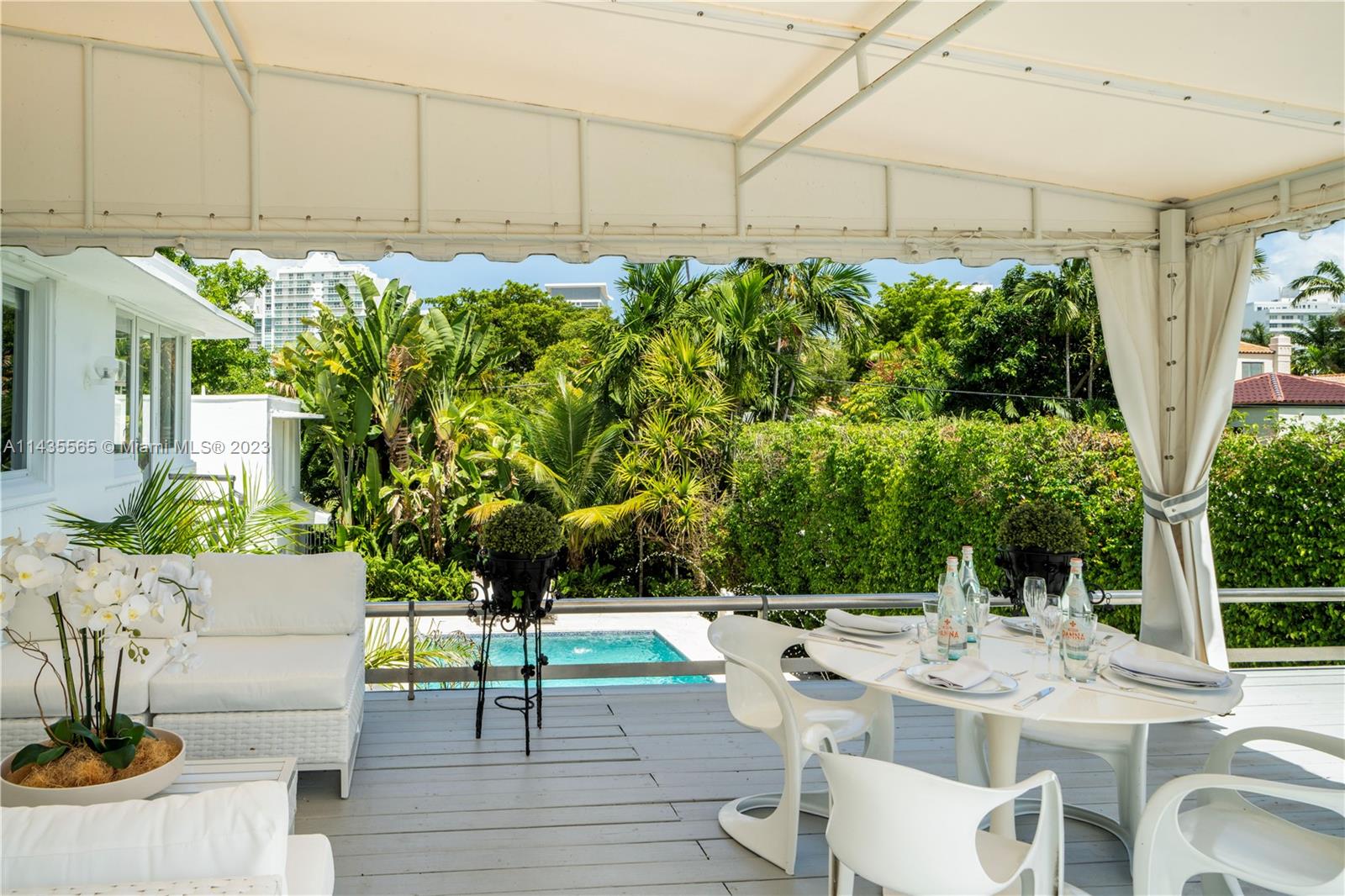 5959 La Gorce Drive Miami Beach, FL 33140 - Photo 40 of 60 a view of a chairs and table in a patio