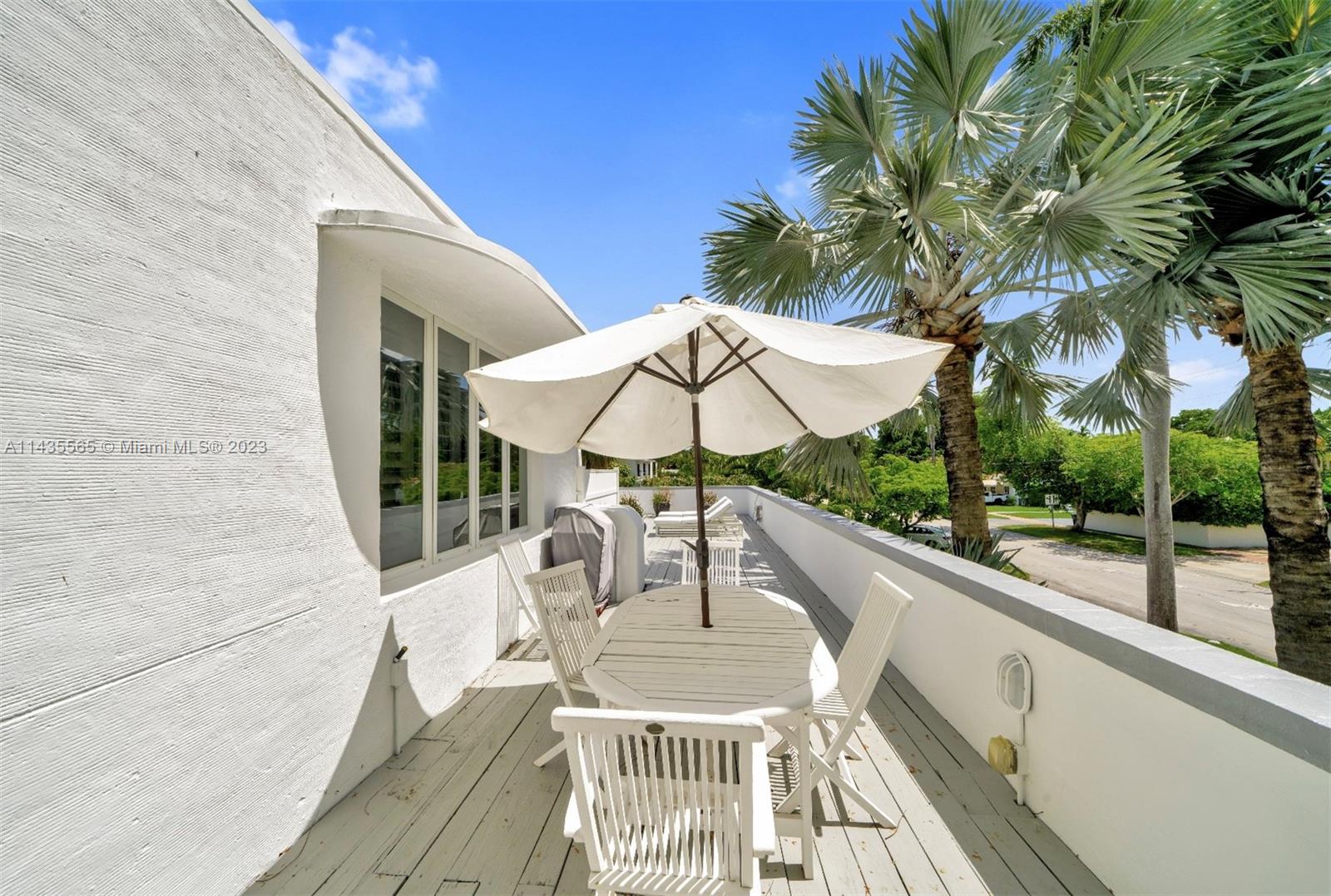 5959 La Gorce Drive Miami Beach, FL 33140 - Photo 42 of 60 a view of a chair and tables in the balcony