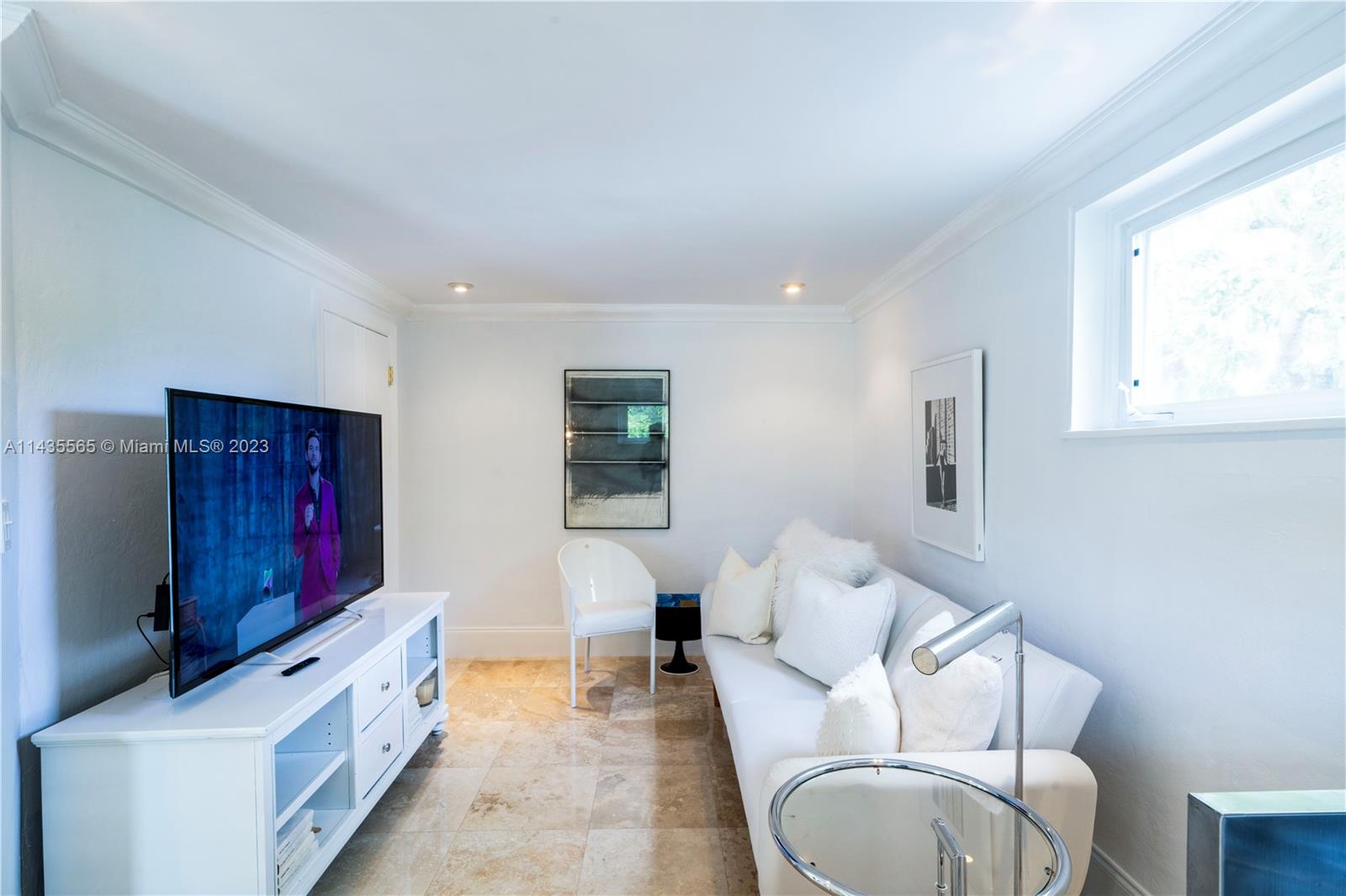 5959 La Gorce Drive Miami Beach, FL 33140 - Photo 50 of 60 a spacious bedroom with a bed and a couch