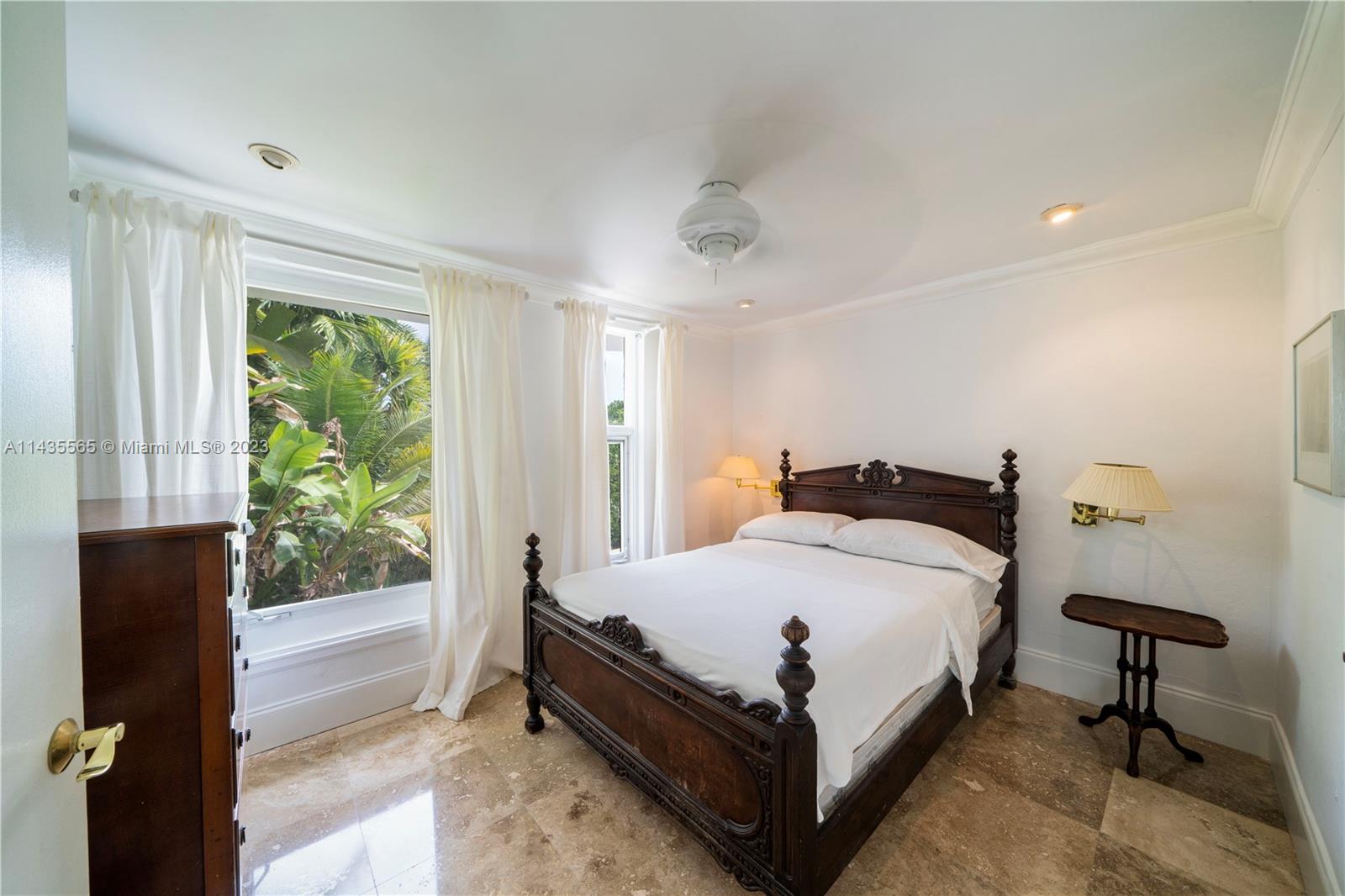 5959 La Gorce Drive Miami Beach, FL 33140 - Photo 51 of 60 a bed sitting in a bedroom next to a window