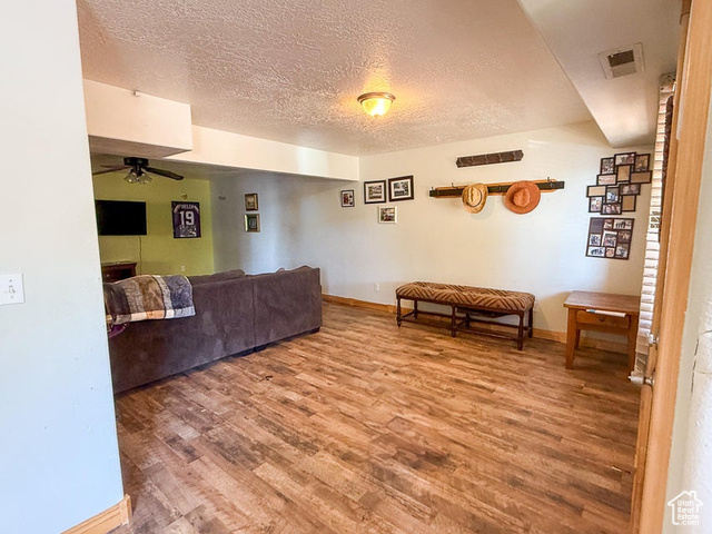 425 East Mule Deer Road Central, UT 84722 - Photo 33 of 72 Living room with wood finished floors, ceiling fan, a textured ceiling, and baseboards