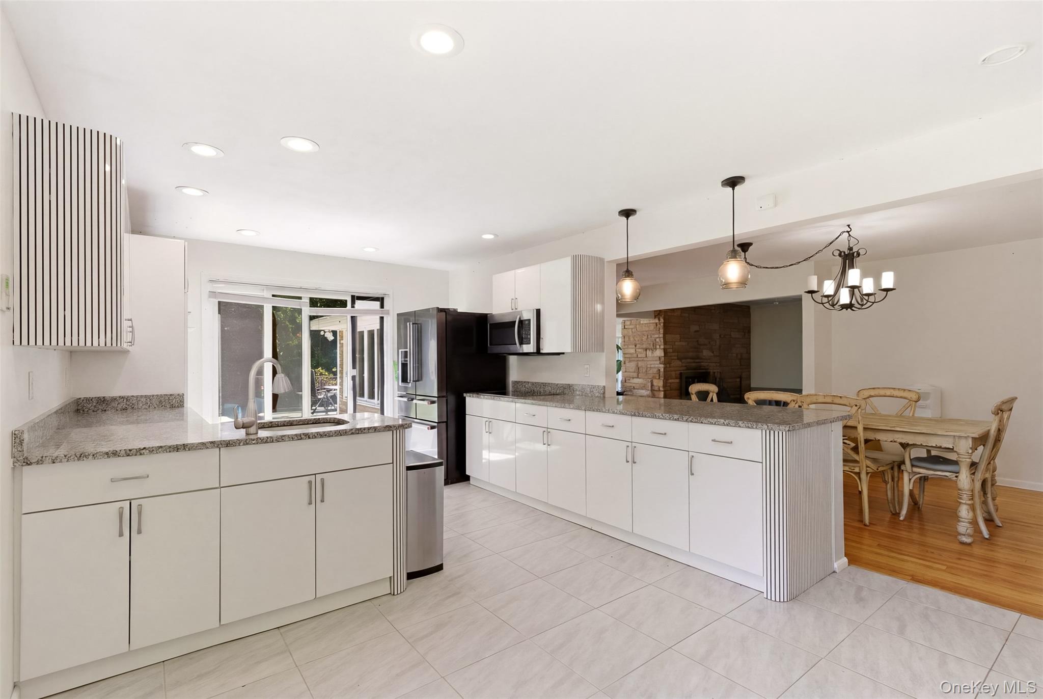 106 Vineyard Road Huntington, NY 11743 - Photo 18 of 25 a large white kitchen with a large window