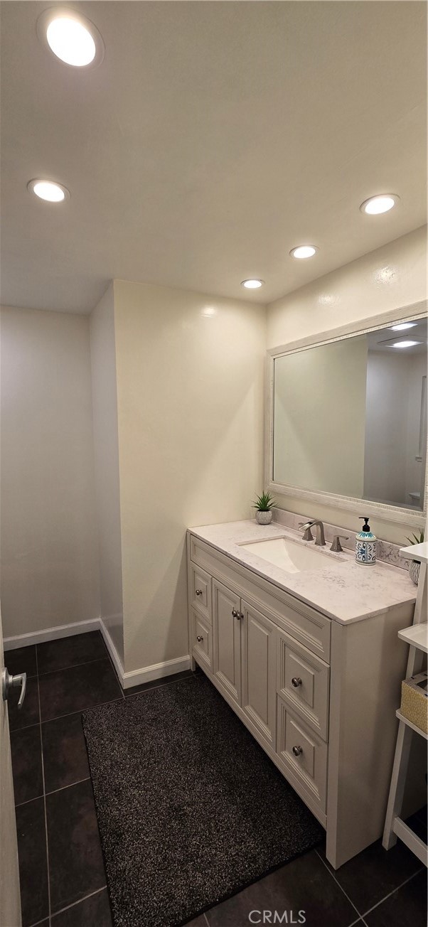 957 Magellan Street Costa Mesa, CA 92626 - Photo 17 of 24 a bathroom with a double vanity sink and mirror