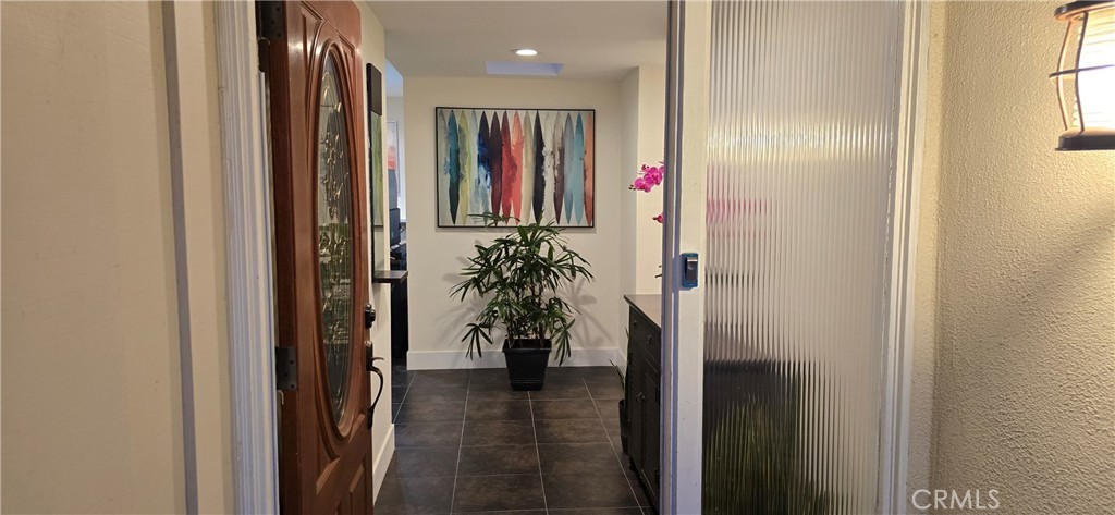 957 Magellan Street Costa Mesa, CA 92626 - Photo 2 of 24 a view of a hallway with paintings on the wall