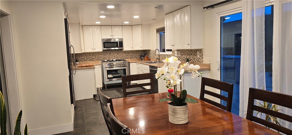 957 Magellan Street Costa Mesa, CA 92626 - Photo 8 of 24 a kitchen with stainless steel appliances granite countertop a refrigerator and a stove top oven