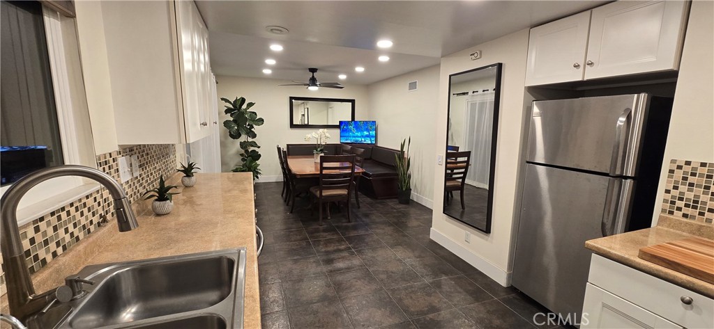 957 Magellan Street Costa Mesa, CA 92626 - Photo 9 of 24 a kitchen with sink refrigerator and stove
