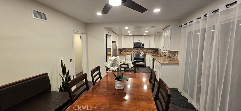 957 Magellan Street Costa Mesa, CA 92626 - Photo 10 of 24 a view of a kitchen with dining room