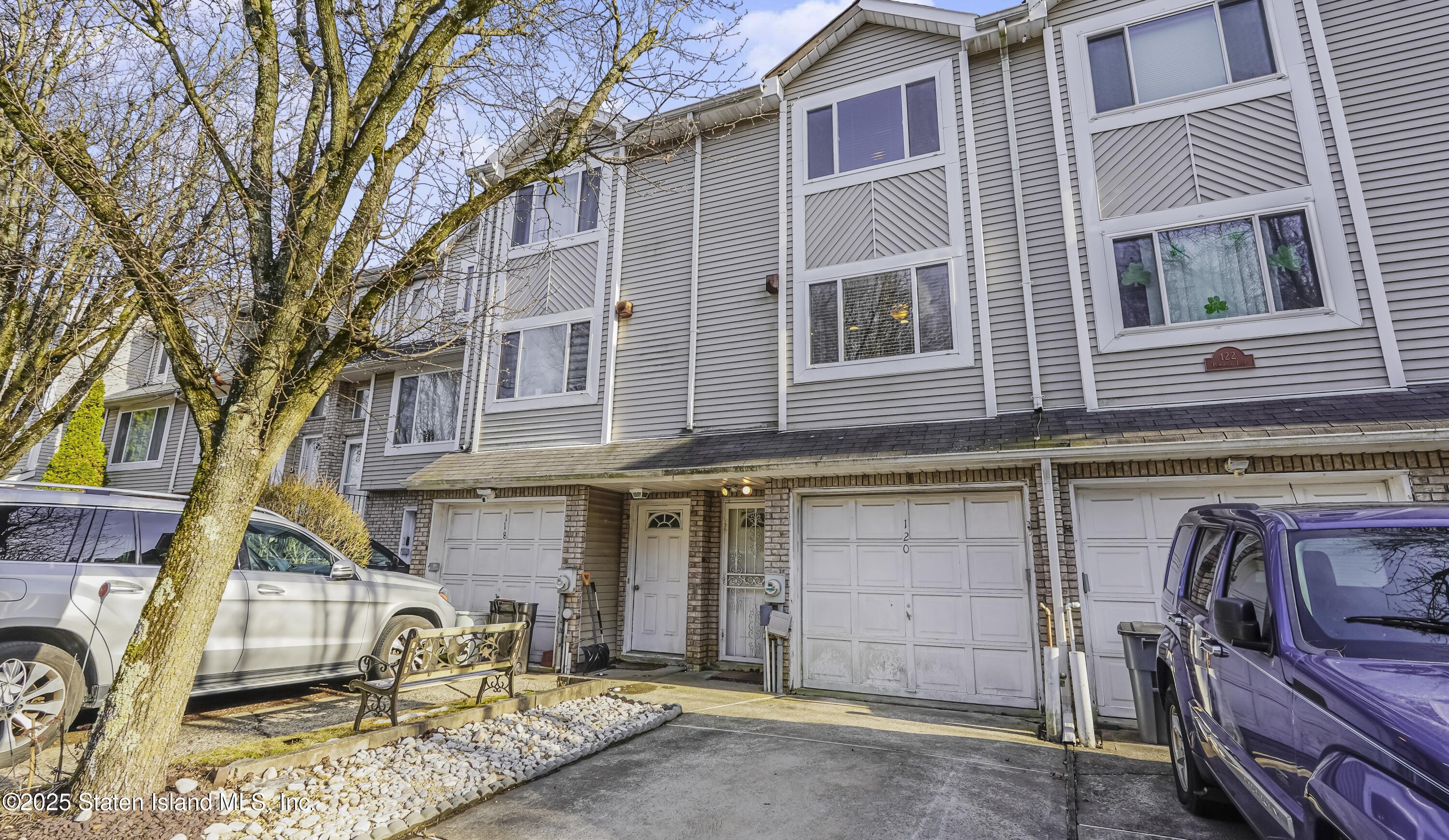 a front view of a house with parking space