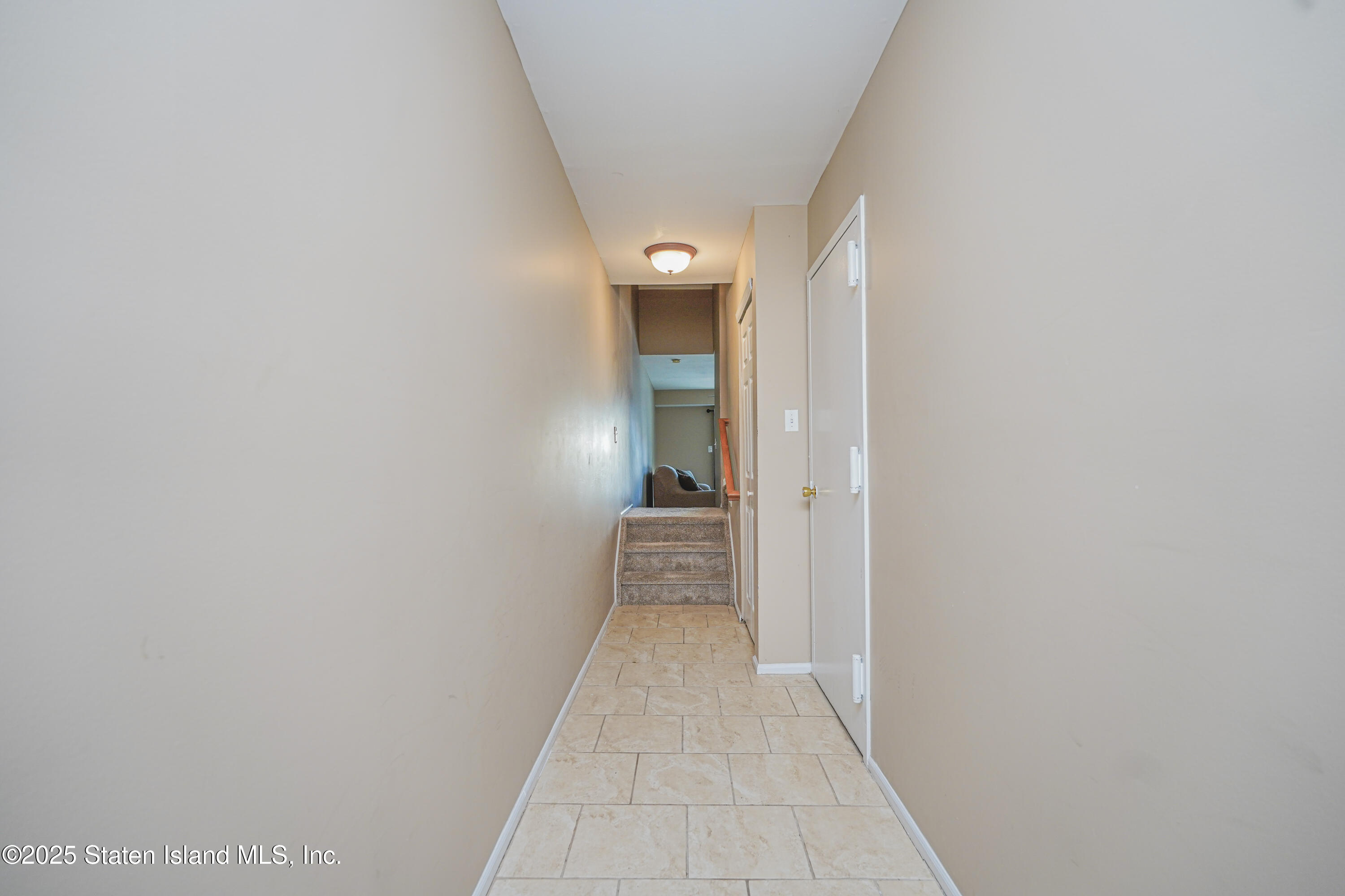 120 Pembrook Loop Staten Island, NY 10309 - Photo 13 of 24 a view of a hallway with wooden floor and a bathroom
