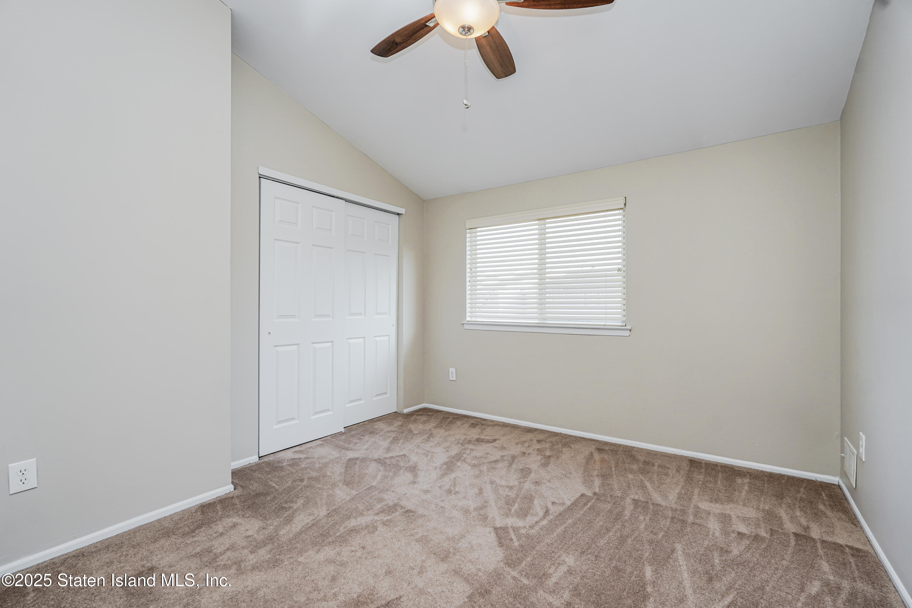 120 Pembrook Loop Staten Island, NY 10309 - Photo 18 of 24 an empty room with ceiling fan and windows
