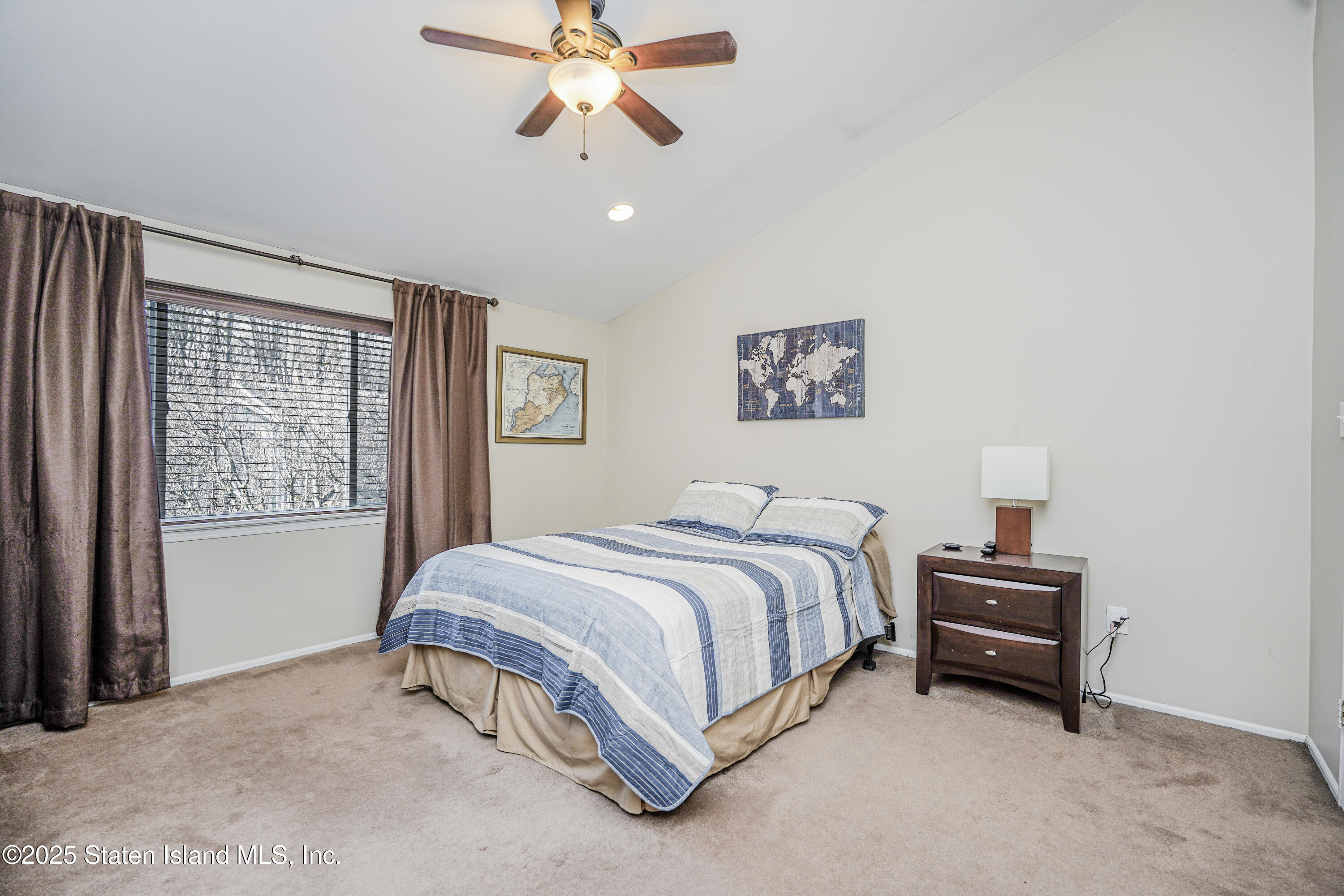 120 Pembrook Loop Staten Island, NY 10309 - Photo 20 of 24 a bedroom with a bed and a chandelier