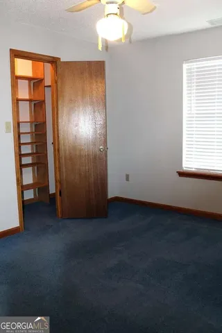 an empty room with closet area