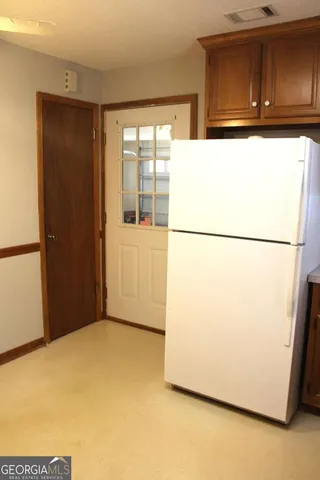 a view of a refrigerator in a kitchen