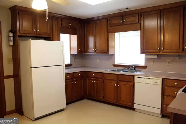 a kitchen with a refrigerator and a sink