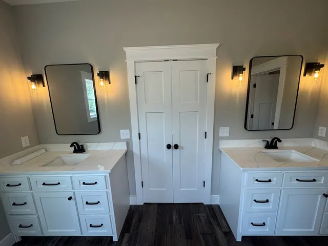 a bathroom with a double vanity sink and mirror