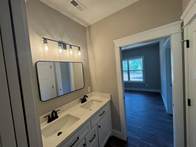 a bathroom with 2 sink and mirror