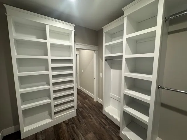 a view of walk in closet with empty racks