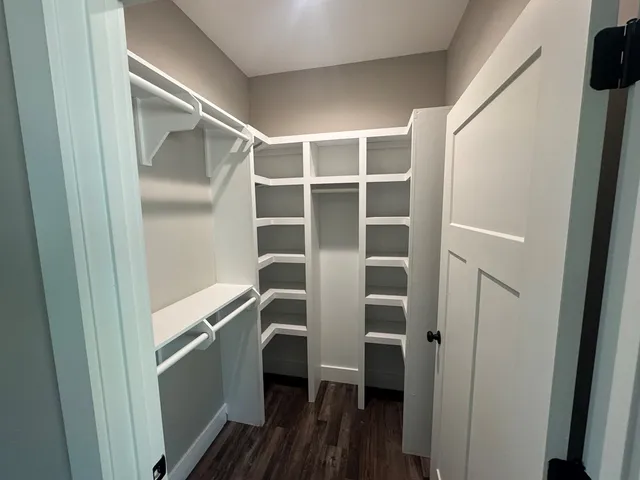 a view of walk in closet with empty racks