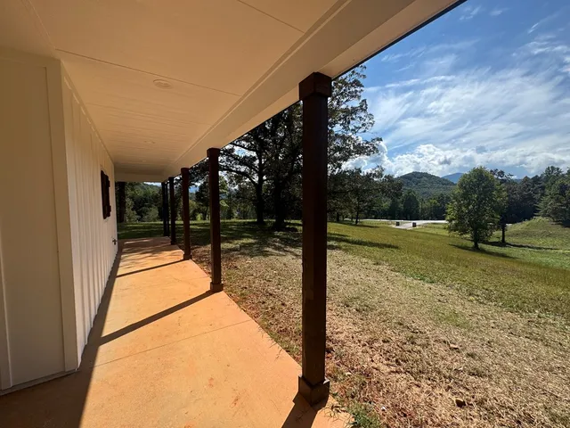 a kitchen with white cabinets and sink