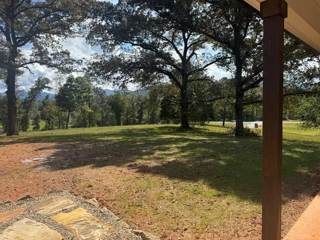 a view of a room with wooden floor and windows