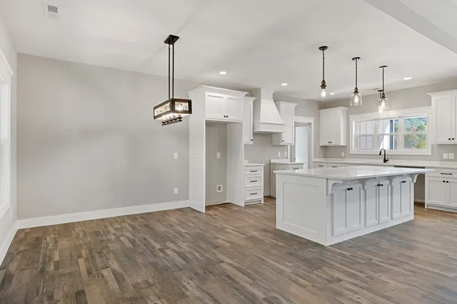 a large white kitchen with stainless steel appliances