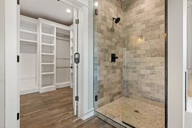 a view of a big room with wooden floor and windows