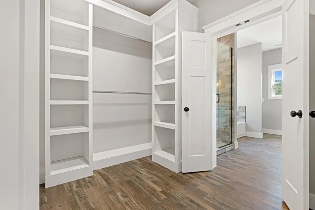 a view of an empty room with a window and a ceiling fan