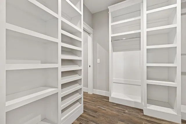 a view of an empty room and wooden floor