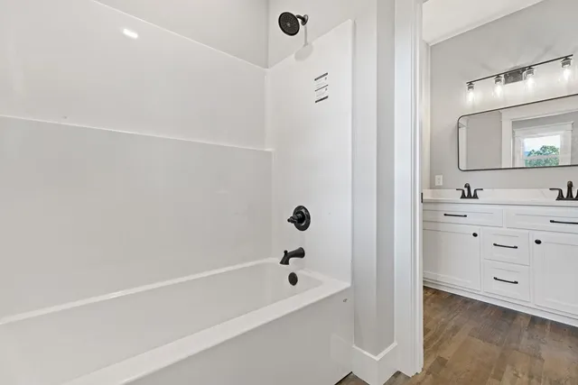 a view of an empty room and wooden floor