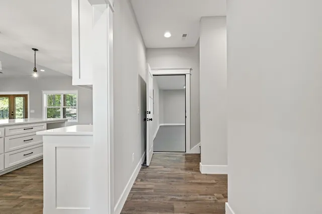 a view of a big yard with plants and large trees