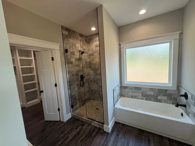 a bathroom with a bathtub and a shower