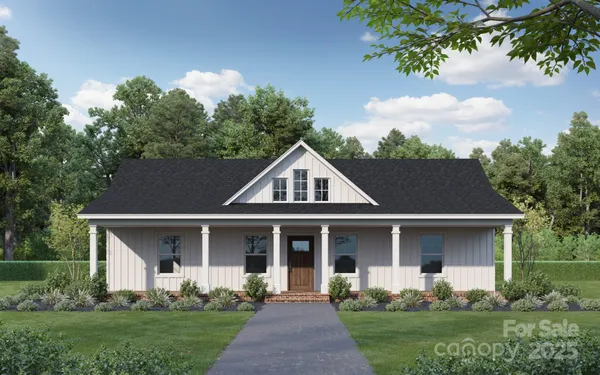 a front view of a house with a yard and trees
