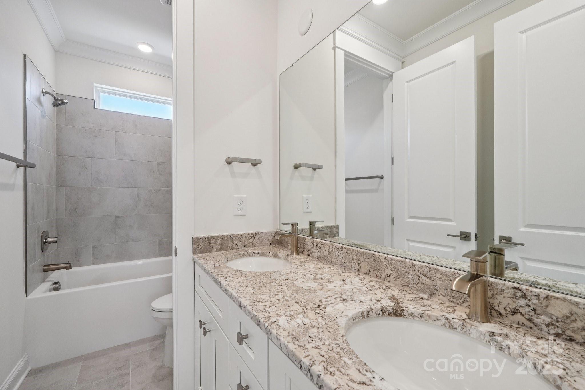 908 Coast Drive Tega Cay, SC 29708 - Photo 11 of 14 a bathroom with a granite countertop tub sink and mirror