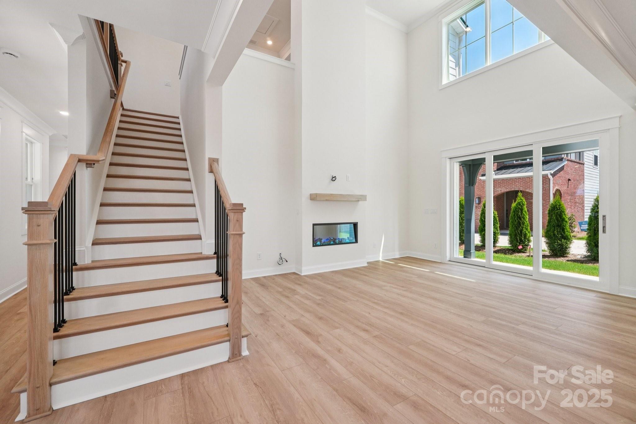 908 Coast Drive Tega Cay, SC 29708 - Photo 4 of 14 a view of a livingroom with wooden floor and stairs