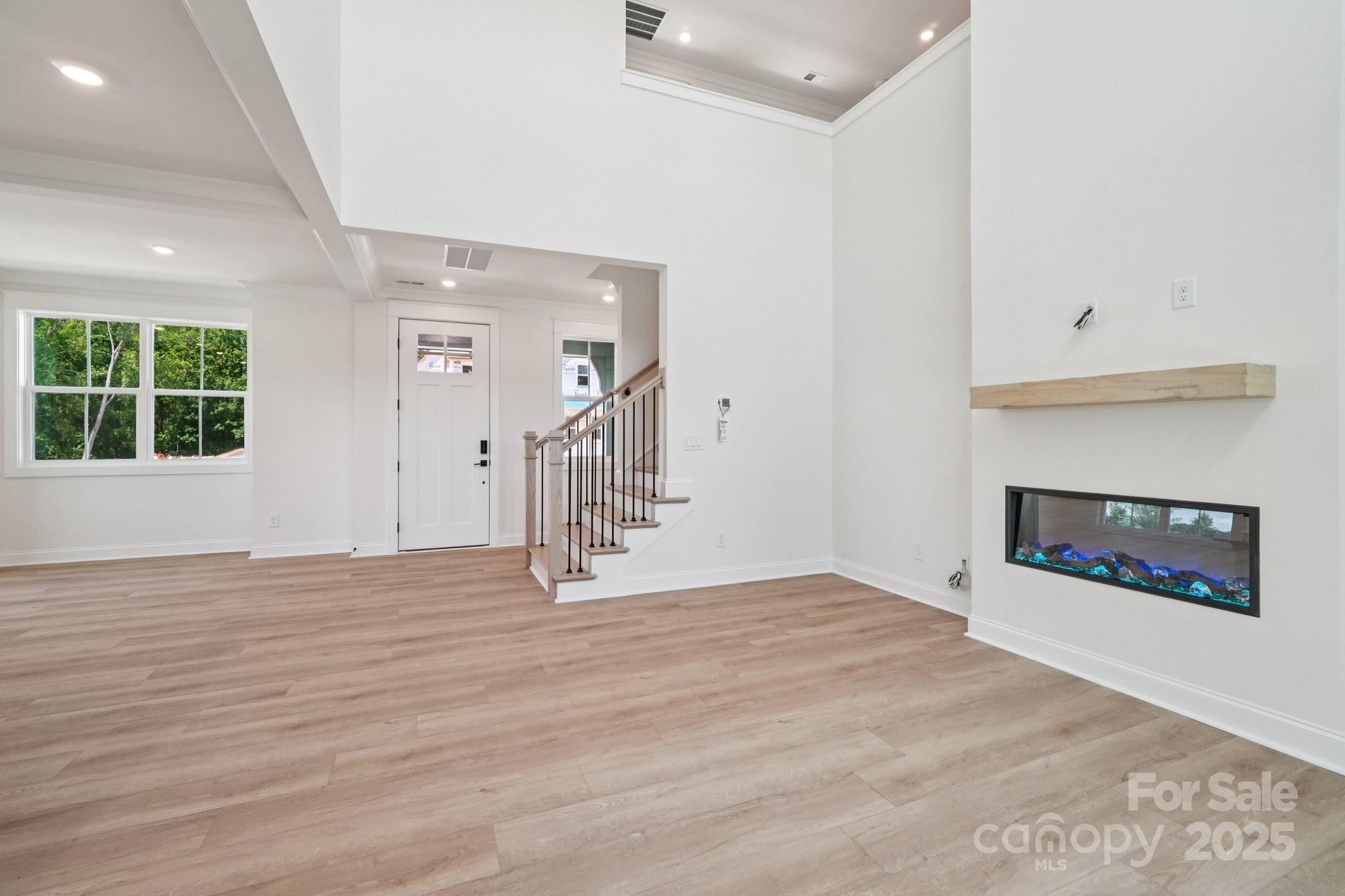 908 Coast Drive Tega Cay, SC 29708 - Photo 5 of 14 an empty room with windows and fireplace
