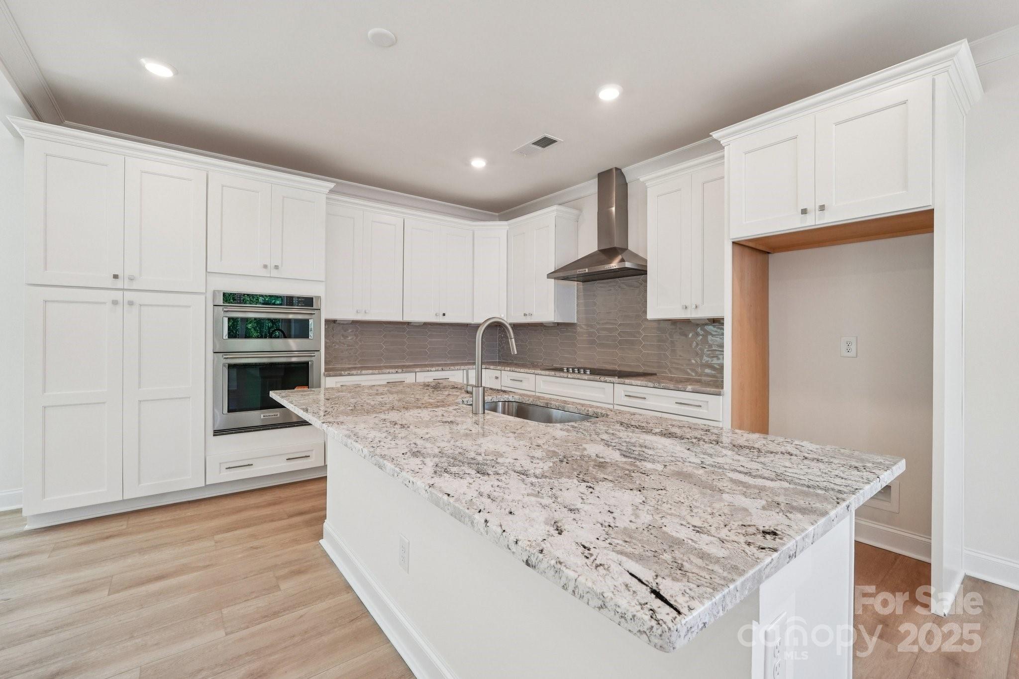 908 Coast Drive Tega Cay, SC 29708 - Photo 6 of 14 a kitchen with stainless steel appliances granite countertop a sink stove and oven